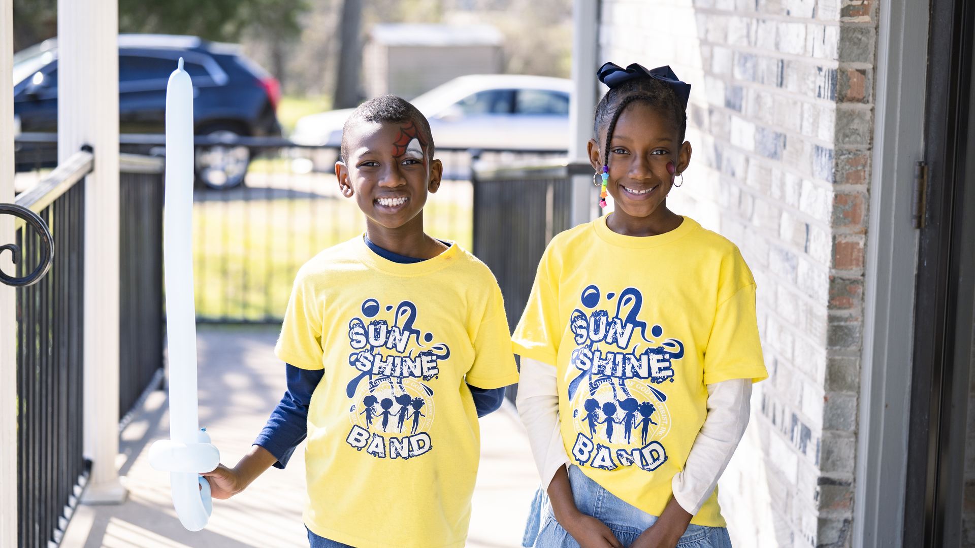 Sunshine Band kids smiling in their yellow shirts