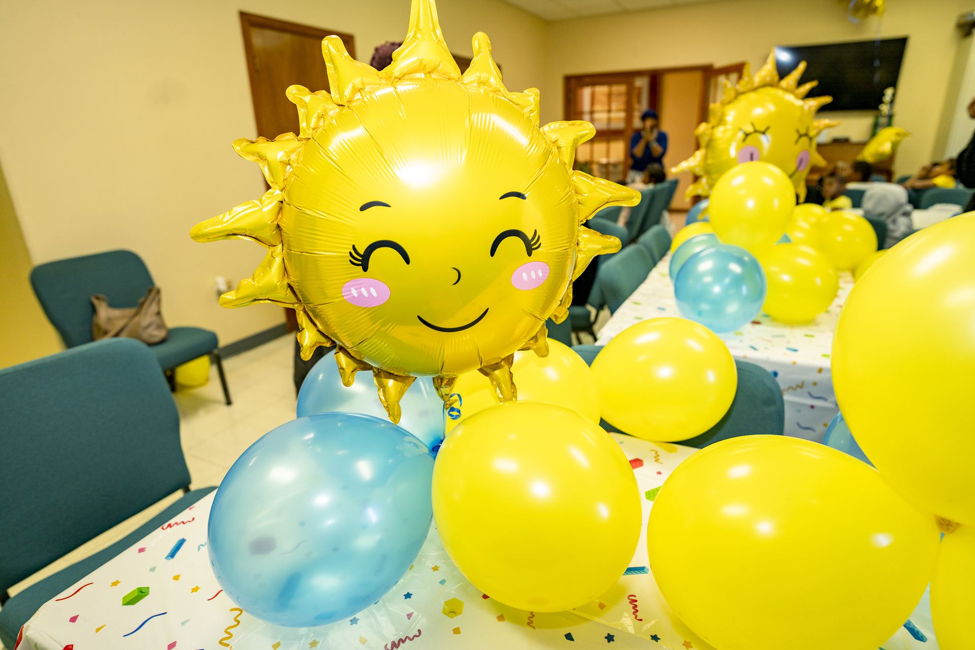 Smiling sun balloon at a Sunshine Band celebration
